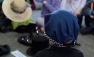 Student wearing a hat that is part of a uniform and a sunhat in the background