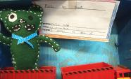 A green soft toy made by a student