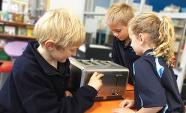 Three students explore a toaster as a technological system