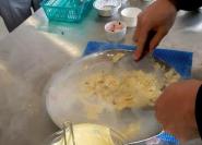 Person mixing ice cream mixture with dry ice on a metal tray