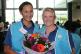 Two students proudly show their floral bouquet