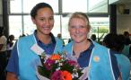 Two students proudly show their floral bouquet