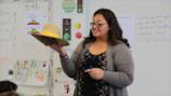 Teacher discussing a hat with her class